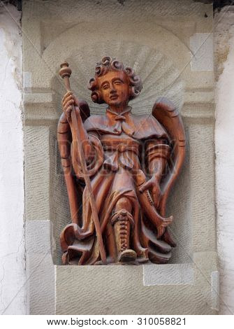 LUCERNE, SWITZERLAND - JUNE 24, 2018: Archangel Raphael statue on the building facade in Lucerne, Switzerland