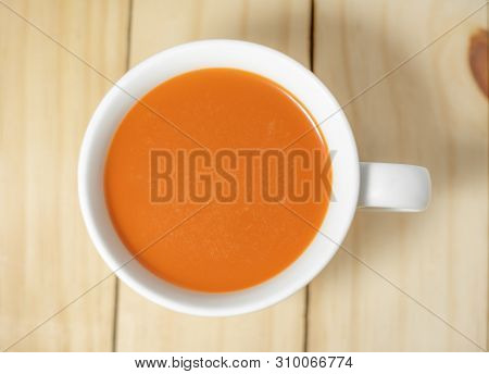 Hot Milk Tea In A White Cup On Wooden Background