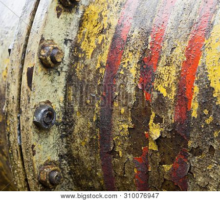 Bolt Coupling On The Old Metal Pipe (tube). Pipeline. Cracked And Damaged Yellow And Red Paint On Th