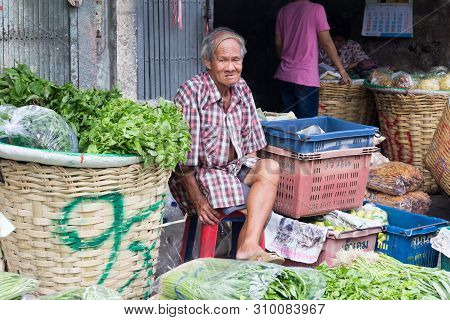 Bangkok, Thailand - July 9th 2015: Vegetable Vendor At Pak Khlong Talat Market Waiting For Business.