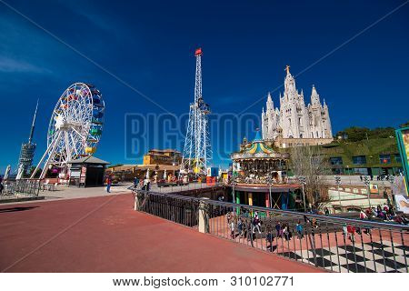 Barcelona, Spain - April, 2019: The Tibidabo Amusement Park On Mount Tibidabo On Background Of Blue