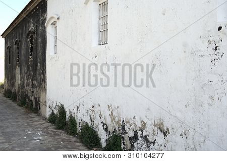 Wall Painted Half Black Half White With Deteriorated Paint And With Windows