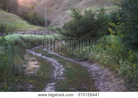 Winding Mountain Road In A Hilly Valley. Rural Highland Landscape, Streets Off The Beaten Path
