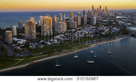 Gold Coast, Australia - May 5 2019: Aerial Reverse Sunset Views With Boats In The Harbour With A Vie