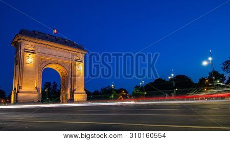 Arc de Triumf in Bucharest Romania at the sunset hour