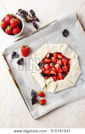 Homemade Strawberry Open Cake Of Gallet With Purple Basil And Balsamic Sauce Before Baking On A Ligh