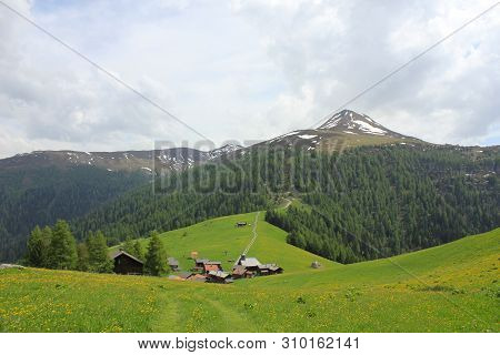Idyllic Village Obermutten In Early Summer And Muttener Horn, Mountain In Switzerland.