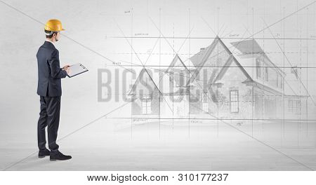 Architect standing and watching an imagined house plan