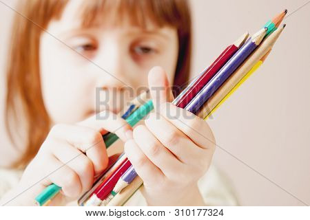 Humoroous Portrait Of Great Artist. Cute Little Child Girl With Colored Pencils.