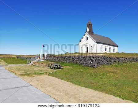 View Of Strandakirkja Church With Flag Of Iceland