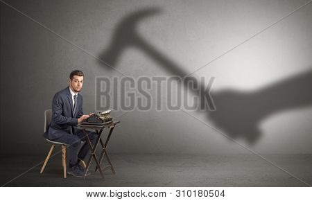 Shadow threatening hard worker man who is afraid