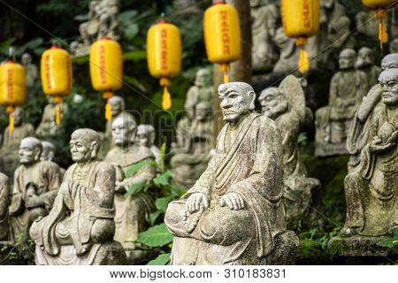 groups of buddhist arhat stone statue in the garden