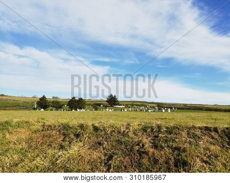 Graveyard On Green Pastures In Idilic Iclandic Landscape