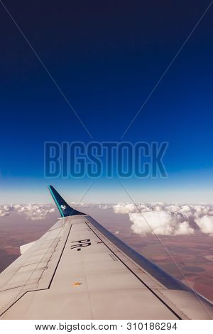 Traveling With Airplain Trough The Blue Sky And White Clouds