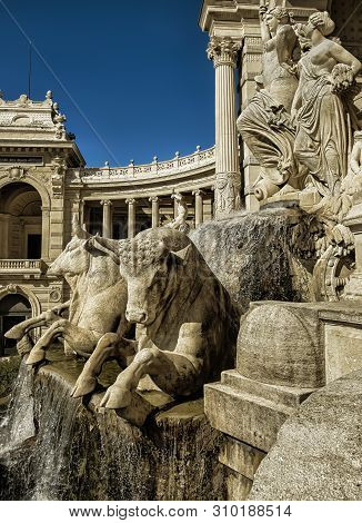 Marseilles, France, March 2019, close up of the fountain known as “water castle” and sculptures of four large bulls and three women in the Palais Longchamp.