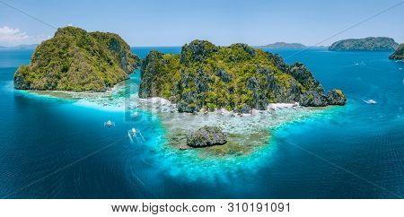 Aerial Drone View Of Tropical Shimizu Island Steep Rocks And White Sand Beach In Blue Water El Nido,
