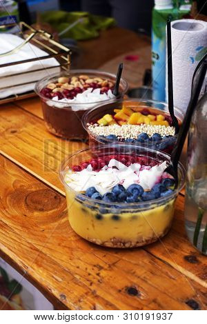 Smoothie Bowl On Street Food Festival With Fresh Raspberries And Coconut. Vegan Nicecream