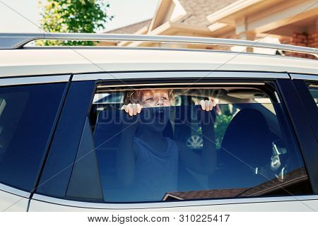 Preschooler Little Caucasian Girl Left Alone In Car During Hot Sunny Day. Child Crying Screaming Try