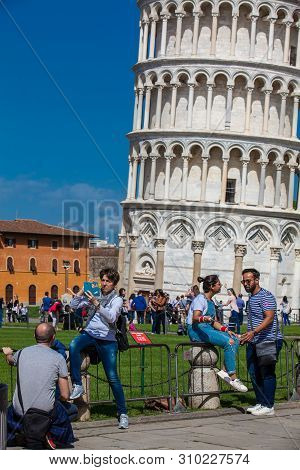 Pisa, Italy - April, 2018: Tourists Posing And Taking Pictures In Front Of The Famous Leaning Tower