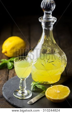 Traditional Italian Lemon Liqueur Limoncello And Fresh Citrus Lemon. Alcoholic Beverage.