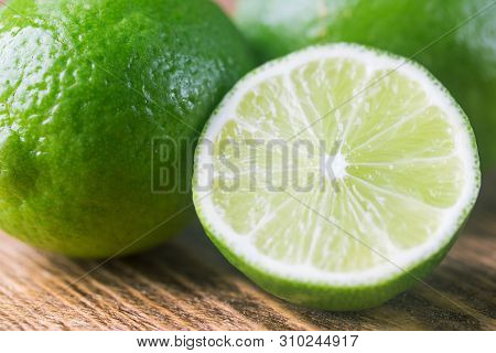 Fruit Lime With Lime Slices Over Wooden Background. Citrus Fruit.