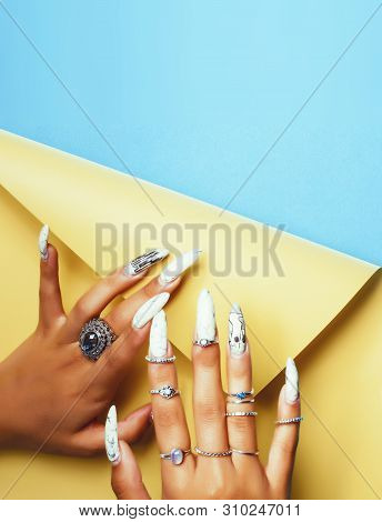 Woman Hands Holding Colorful Paper Copyspace Wearing A Lot Of Jewelry And Long Nails