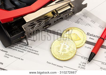 Still Life Of Cryptocurrency Investment. Bitcoin And Ethereum Souvenir Coins With Video Card Layed O