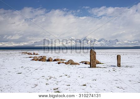 Traditional Memorable Stones On The Shore Of Son-kul Lake On The Background Of Snow-capped Mountains