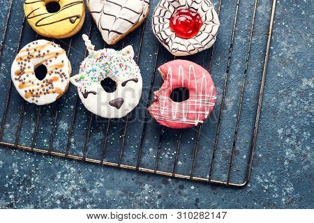 Frosted Donuts With Bite Missing On Dark Background.