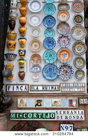 Ronda, Spain - May 5, 2008 - Colourful Ceramic Plates And Pots On A Shop Wall In The Old Town, Ronda