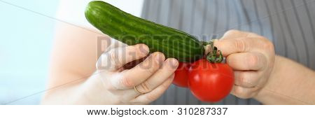 Chef Hands Showing Humorous Vegetable Phalos. Comic Male Joking With Tomato And Cucumber. Man Holdin