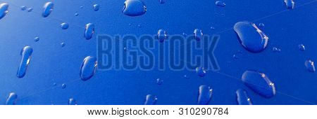 Drops Of Rainwater On Blue Metal Background After Nanoceramics Polishing Technology Closeup