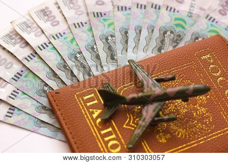 Russian Money And Passport On White Background, Close-up, Passport And Money Fan In Hand. Travel Age