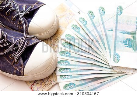 Russian Money On A White Background, Close-up, Passport And Money Fan In Hand. Travel Agency. Buying