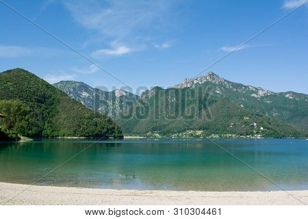 View Of Lake Ledro With Swimming Ducks On The Foreground. Trento, Italy