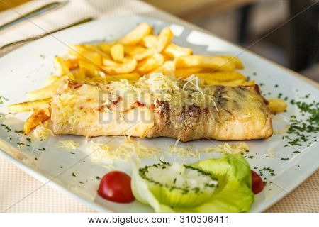 Traditional Montenegrin Meat Negush Steak On A White Plate In A Restaurant.