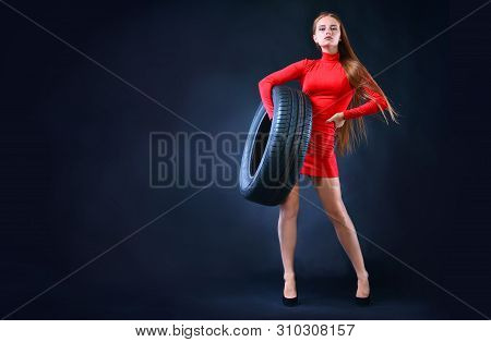Woman Holding Tire In Her Hands. Car Tires Background. Banner With Copy Space.