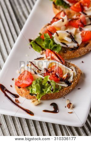Bruschetta With Tomatoes, Lettuce, Camambert, Balsamic Vinegar