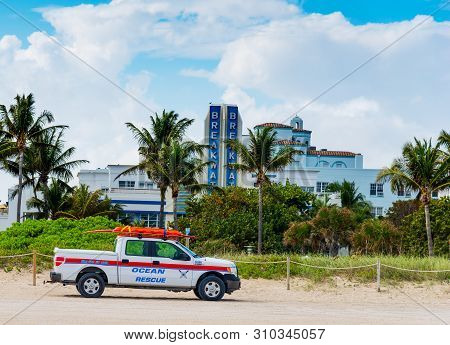 Miami Beach, Usa - Febraury 26, 2019: Ocean Rescue Truck With Breakwater Hotel On The Background In 