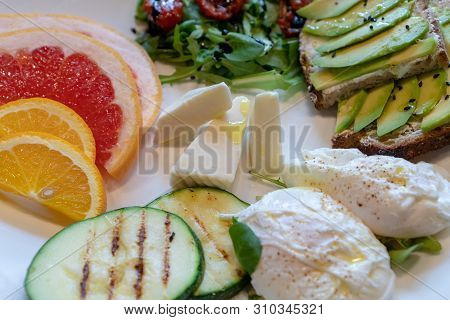 Delicious Healthy Breakfast. Toasts With Avacado, Dried Tomatoes, Cheese, Apelsin, Grapefruit, Poach