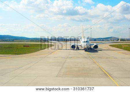 Airplane On Runway At Airport. City In The Background. Turkey