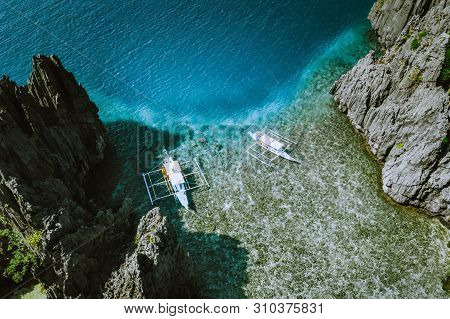 Aerial Shot Of The Philippines Islands In Palawan. Banca Boats In The Morning Shallow Water Neat To 