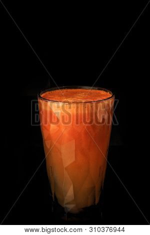 Fresh Raw Carrot Juice In Tall Faceted Plastic Glass