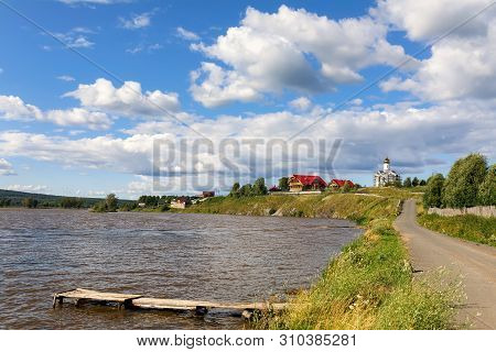 Lake With An Old Wooden Pier On A Sunny Summer Day. Village Of Visim, Sverdlovsk Region, Russia.