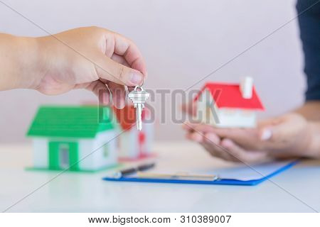 Mortgage Concept. Male Hand Holding Key