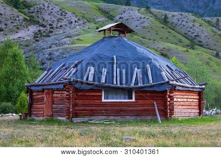 The Ancient Antique Ail House From Wood Is Round-shaped With A Chimney On Top Of The Center, For The