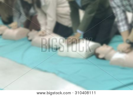 Blurred People Traning On Cpr Course For Saving Another Life In Emergency Case.