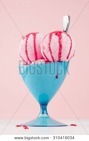 Tasty Fresh Pink Ice Cream In Blue Bowl With Strawberry Sauce, Silver Spoon On White Wooden Table An