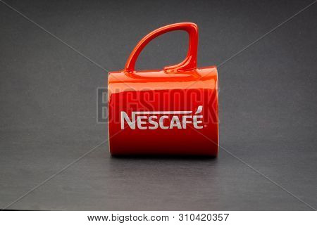Kuala Lumpur, Malaysia - July 03, 2019; Promotional Red Nescafe Mug On Dark Background. Selective Fo