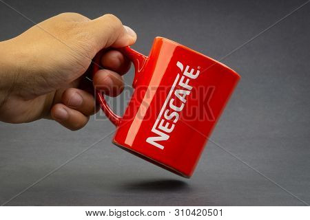 Kuala Lumpur, Malaysia - July 03, 2019; Promotional Red Nescafe Mug On Dark Background. Selective Fo